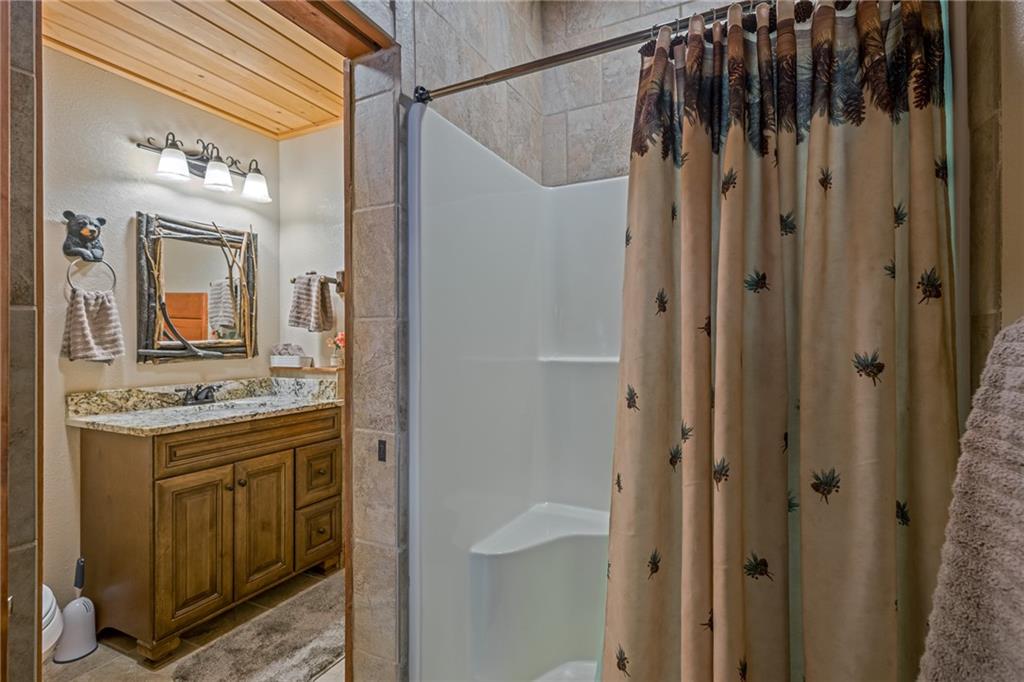 415 Kestrel Rdg Circle Murphy, NC 28906 - Photo 57 of 104 a bathroom with a granite countertop sink a mirror and shower