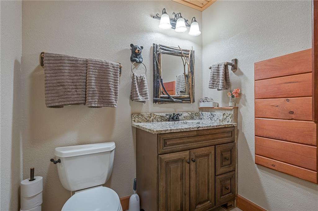415 Kestrel Rdg Circle Murphy, NC 28906 - Photo 58 of 104 a bathroom with a granite countertop toilet sink and mirror
