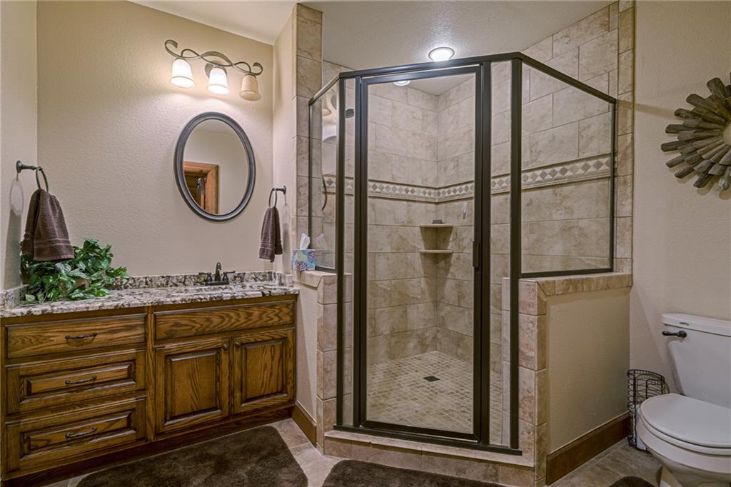 415 Kestrel Rdg Circle Murphy, NC 28906 - Photo 74 of 104 a bathroom with a granite countertop sink toilet a mirror and shower