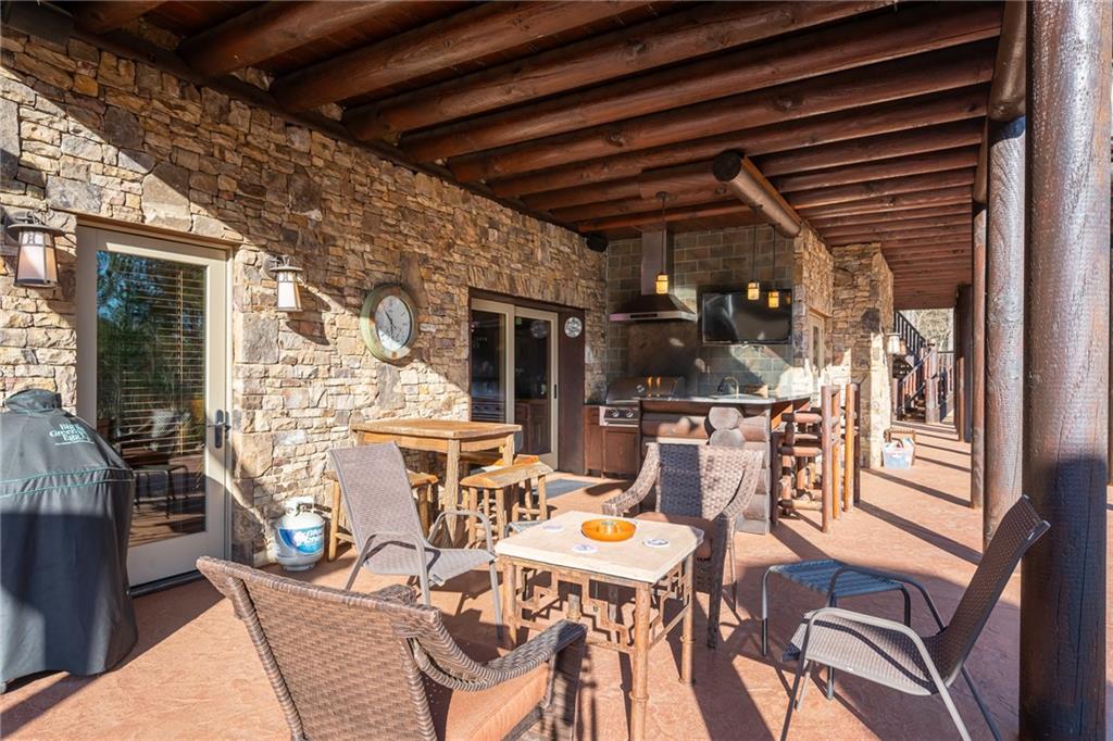415 Kestrel Rdg Circle Murphy, NC 28906 - Photo 99 of 104 a view of a patio with table and chairs and potted plants