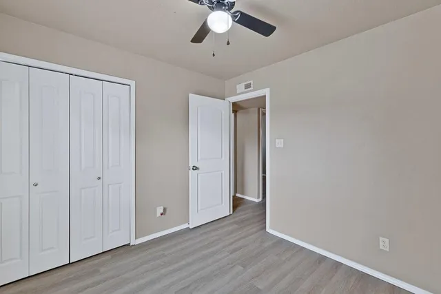 a view of an empty room and wooden floor