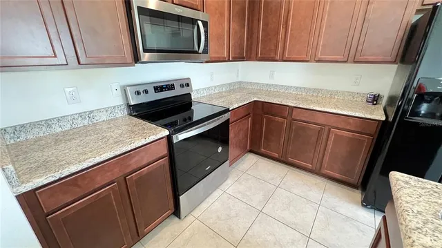 a kitchen with granite countertop cabinets washer and dryer