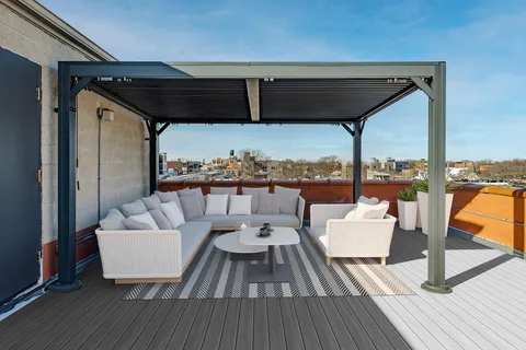 a balcony with wooden floor and furniture