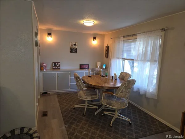 a view of a dining room with furniture and window