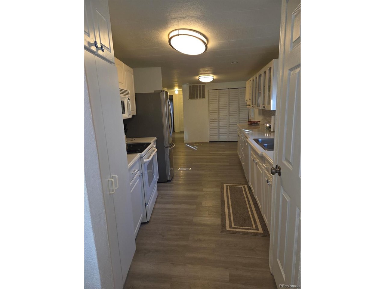 15296 39th Road Sterling, CO 80751 - Photo 22 of 31 a view of a hallway with wooden floor