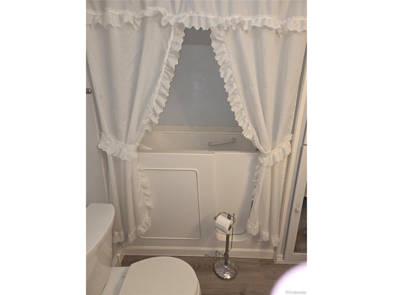 15296 39th Road Sterling, CO 80751 - Photo 27 of 31 a living room with furniture and a floor