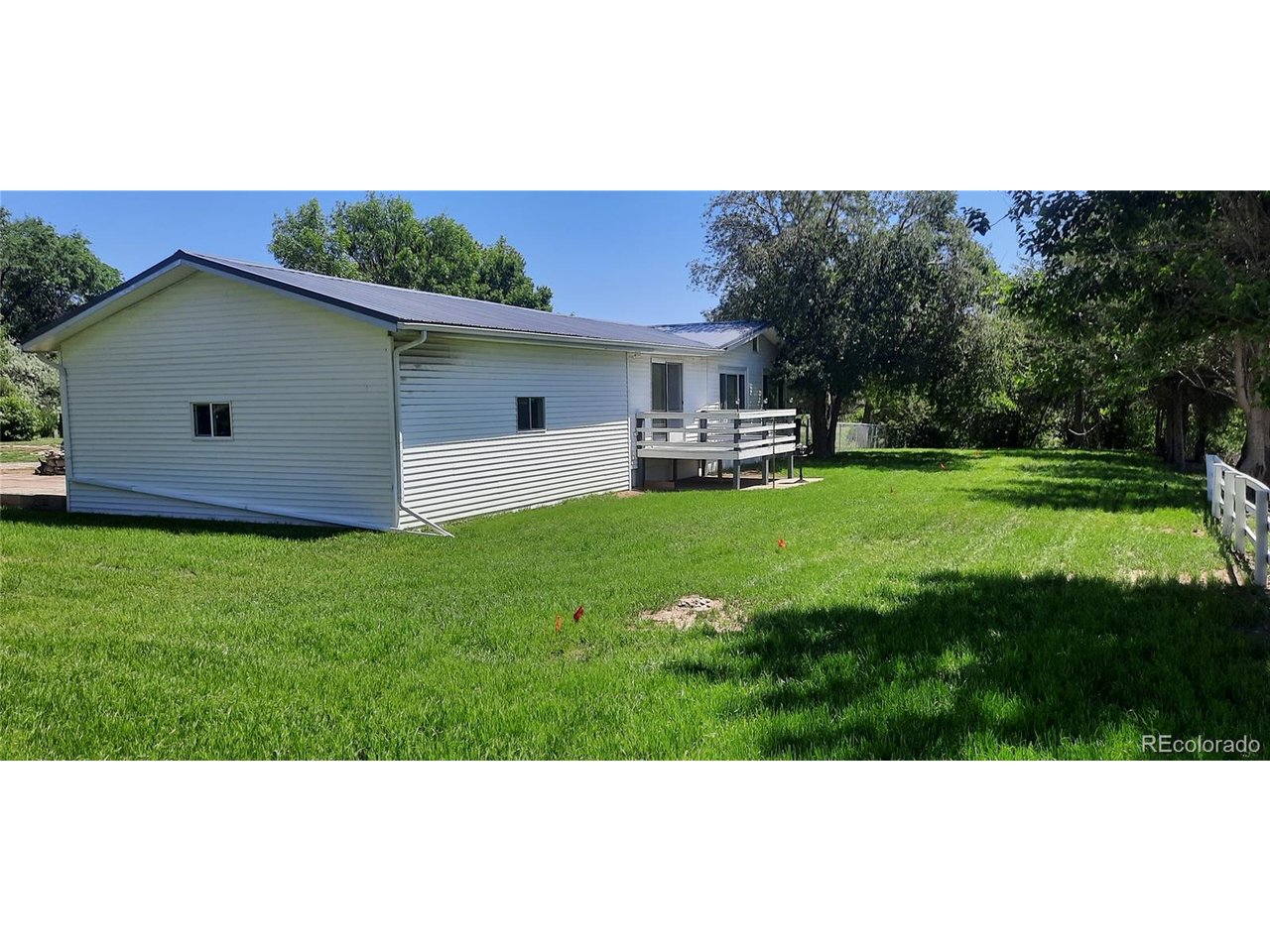 15296 39th Road Sterling, CO 80751 - Photo 4 of 31 a backyard of a house with table and chairs