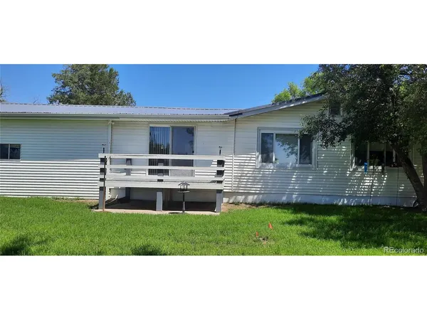 a view of a house with a backyard porch and sitting area