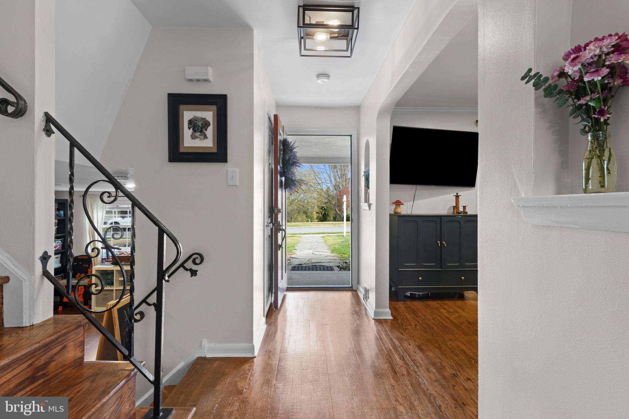 502 Ridge Avenue Kennett Square, PA 19348 - Photo 11 of 60 a view of a hallway with wooden floor and a flat screen tv