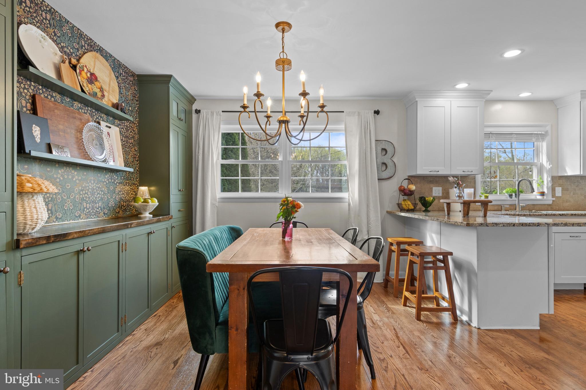 502 Ridge Avenue Kennett Square, PA 19348 - Photo 13 of 60 a kitchen with stainless steel appliances granite countertop a dining table chairs and granite counter tops