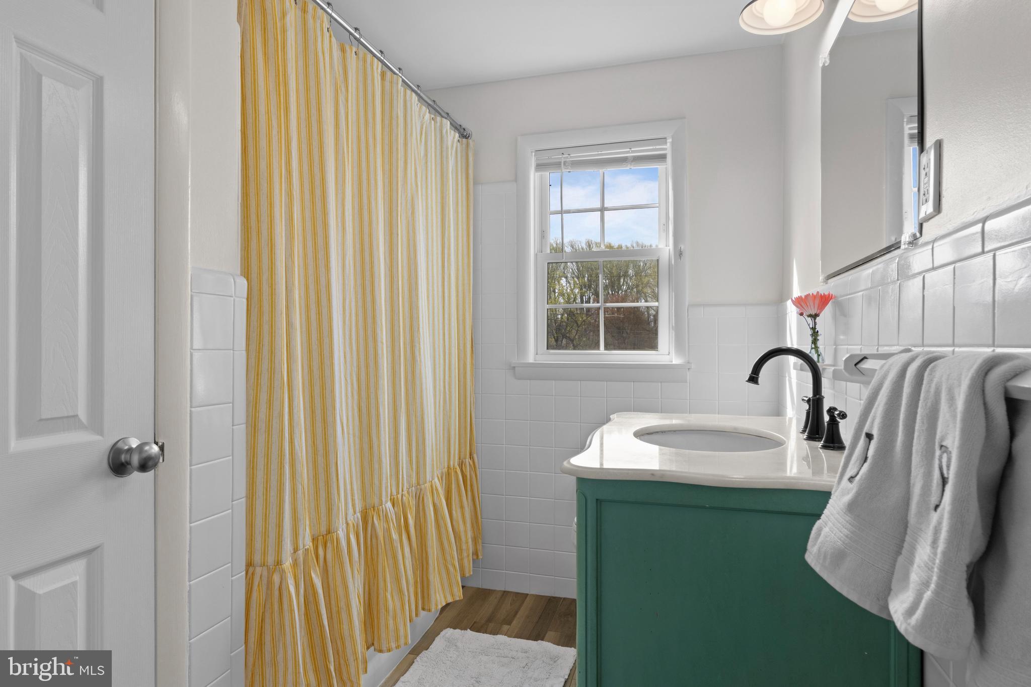502 Ridge Avenue Kennett Square, PA 19348 - Photo 28 of 60 a bathroom with a sink a mirror and a bathtub
