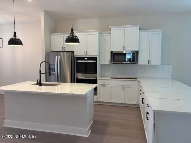 a kitchen with granite countertop a sink and a stove top oven
