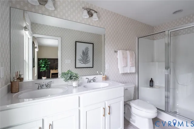 a bedroom with a bed a mirror and next to a window