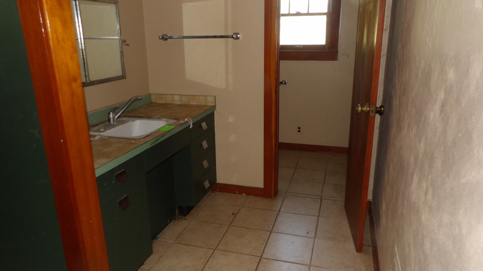 606 Bohn Street Rosiclare, IL 62982 - Photo 4 of 12 a bathroom with a granite countertop sink a mirror and a shower