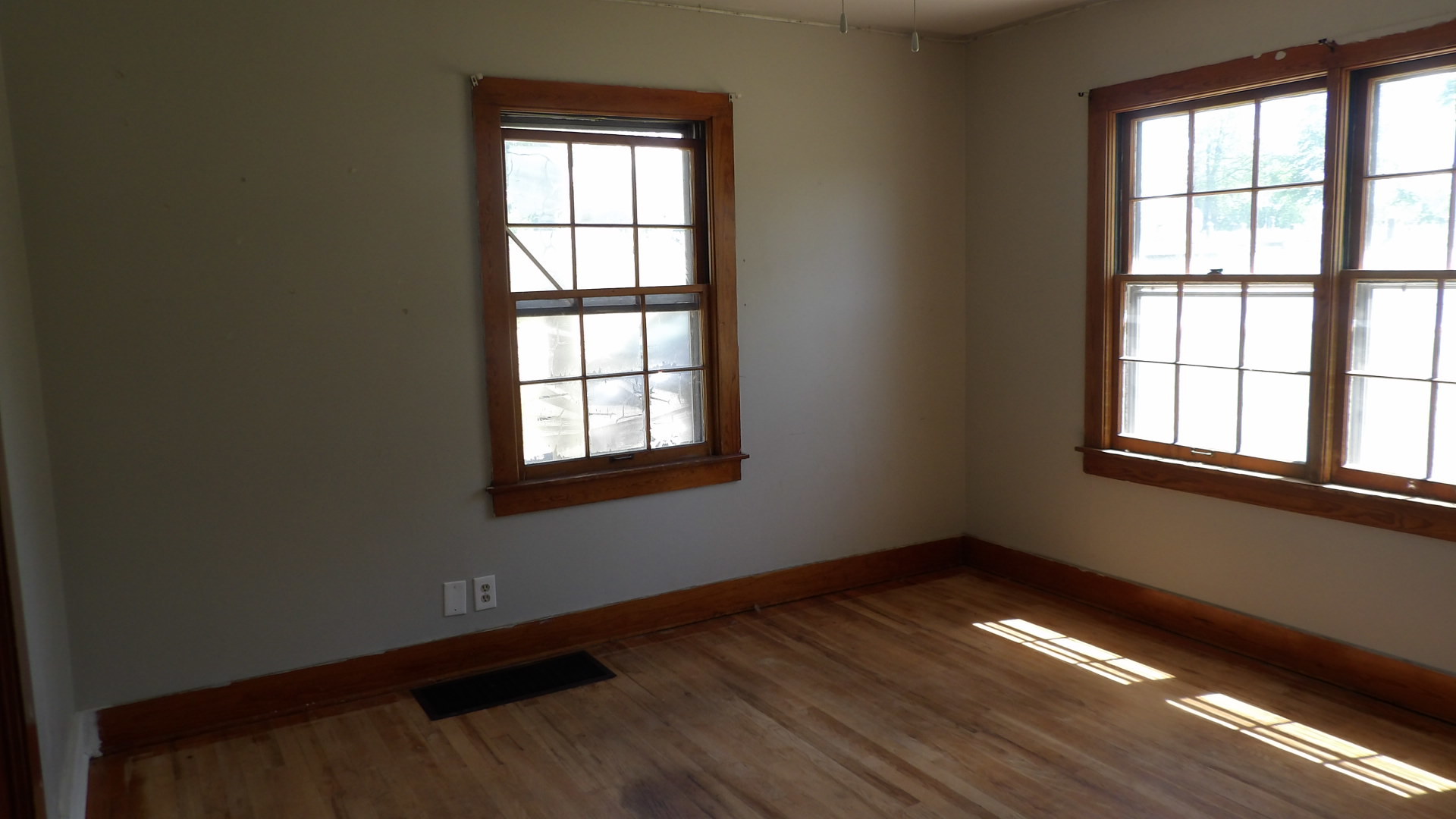 606 Bohn Street Rosiclare, IL 62982 - Photo 6 of 12 a view of an empty room with wooden floor and a window