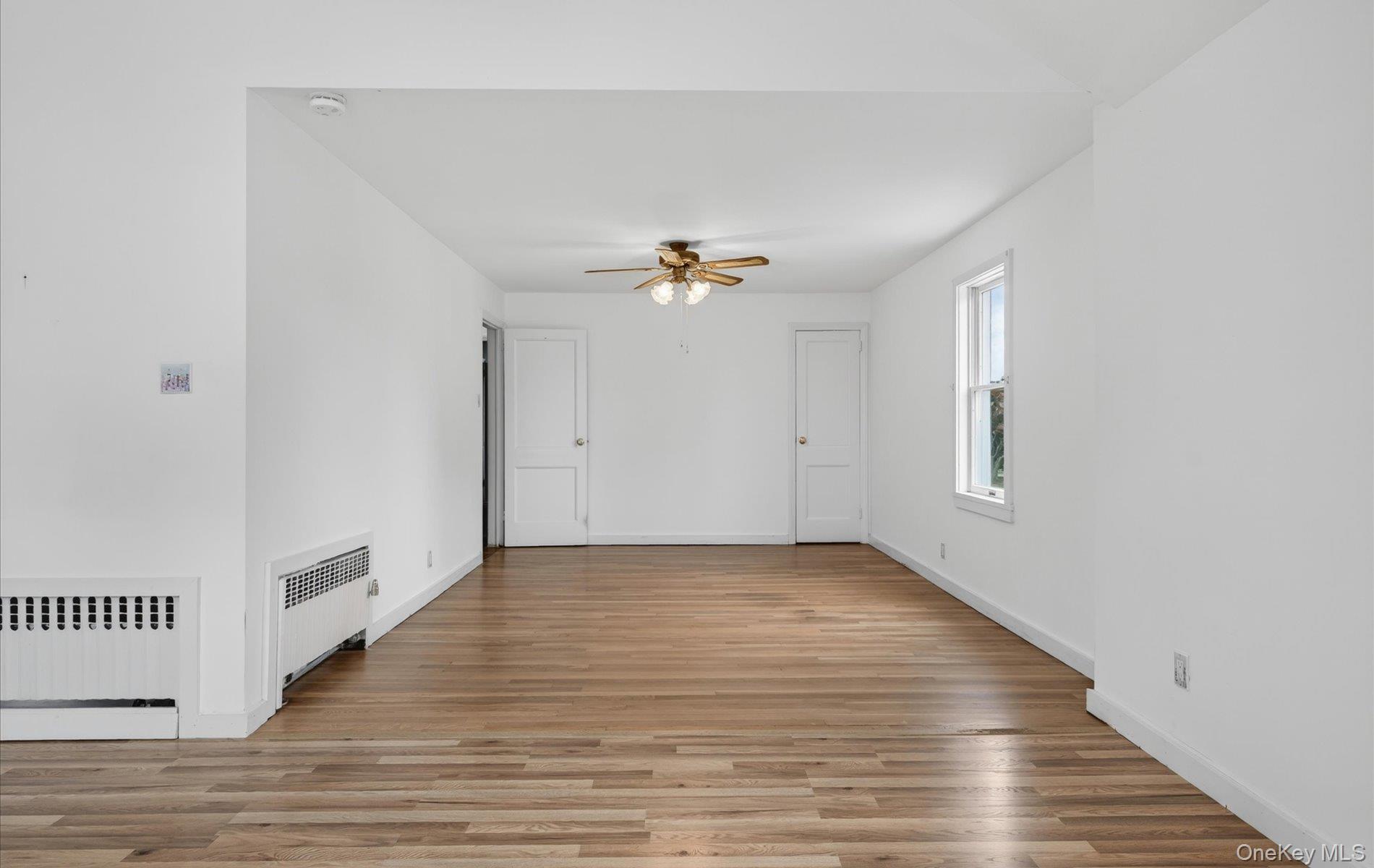 24 Purdue Road Glen Cove, NY 11542 - Photo 28 of 41 a view of an empty room with wooden floor and a window