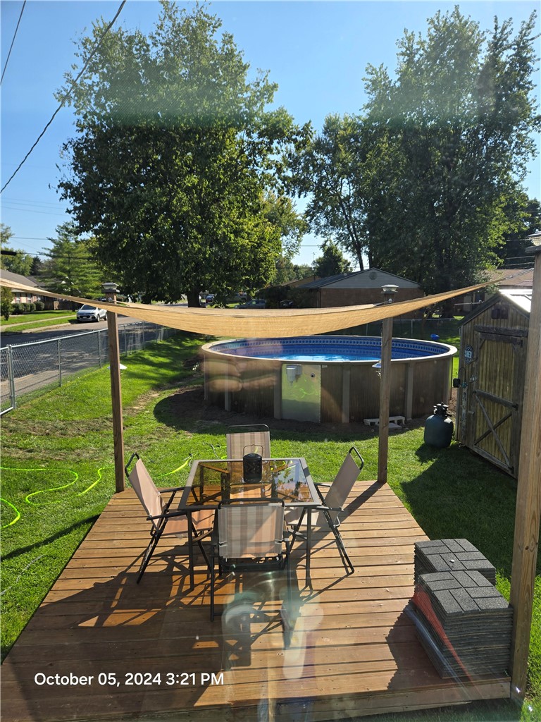 321 Liberty Street Eaton, OH 45320 - Photo 6 of 34 This inviting backyard oasis features a spacious deck and a sparkling above-ground pool.