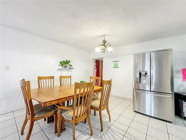 a view of a dining room with furniture and chandelier