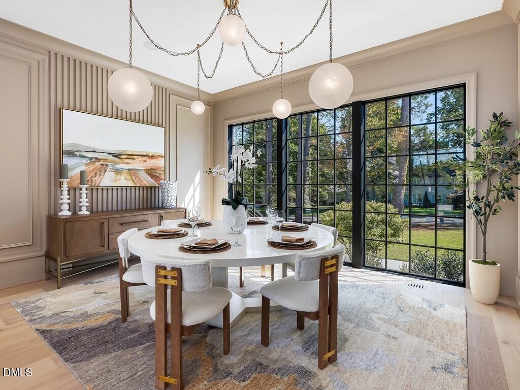 7013 Buckhead Drive Raleigh, NC 27615 - Photo 13 of 80 a view of a dining room with furniture wooden floor and chandelier