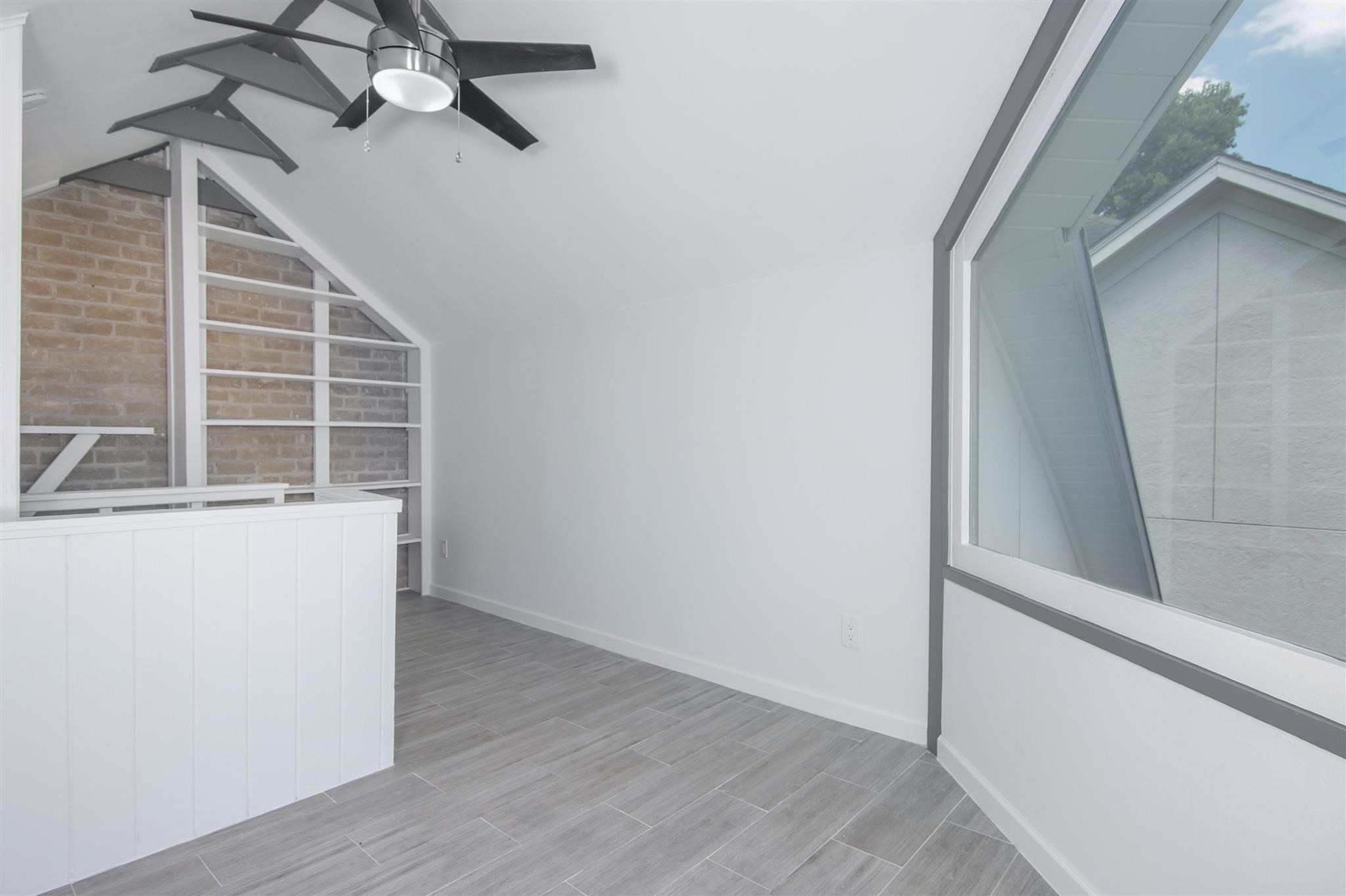 1942 Indiana Street Houston, TX 77019 - Photo 16 of 40 Third floor loft offers built-in storage shelves and plenty of natural light. A great space for a home office, studio or just extra storage.