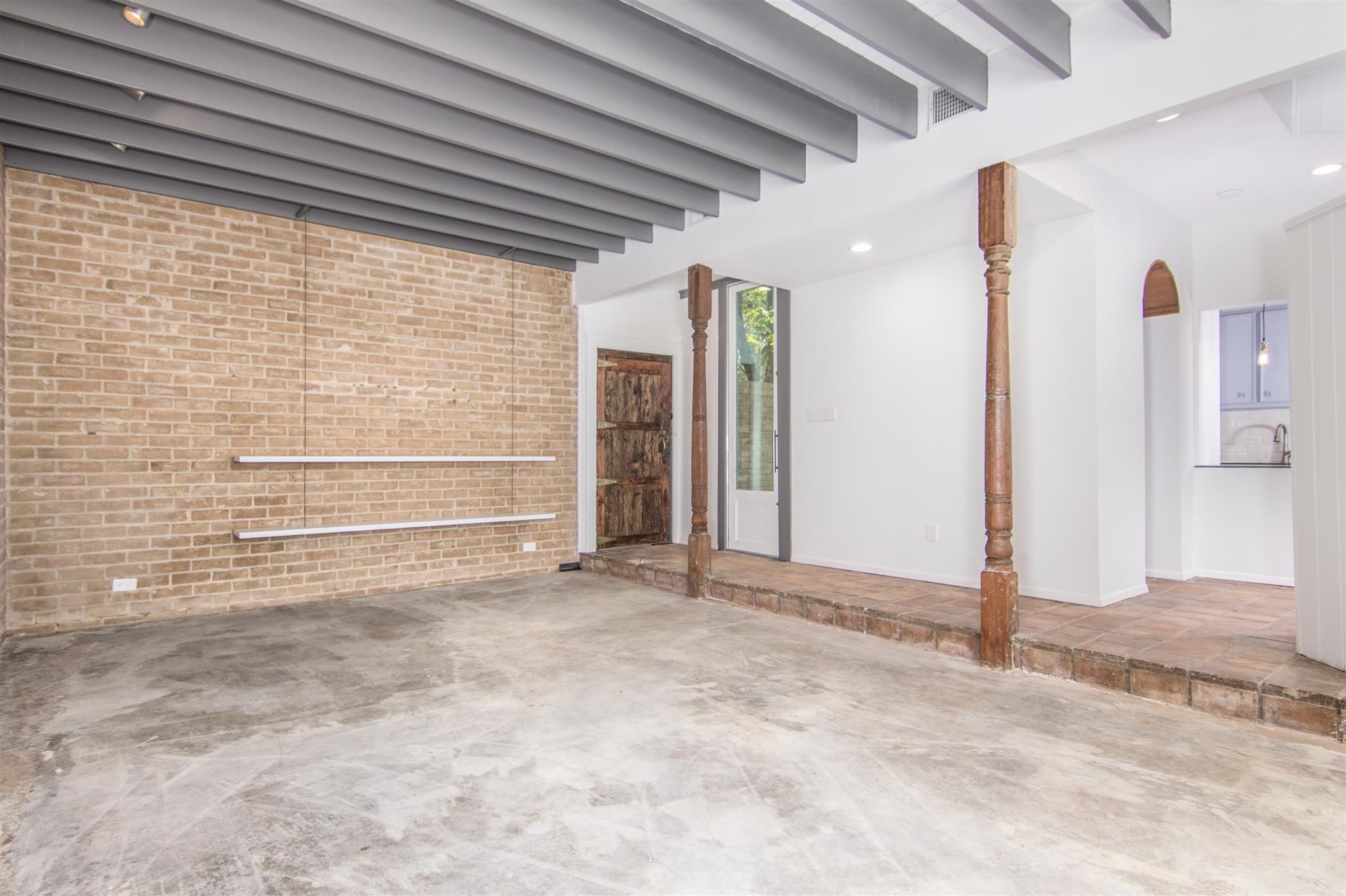 1942 Indiana Street Houston, TX 77019 - Photo 22 of 40 A view of the living room from the back of the house, toward the front door and the kitchen.