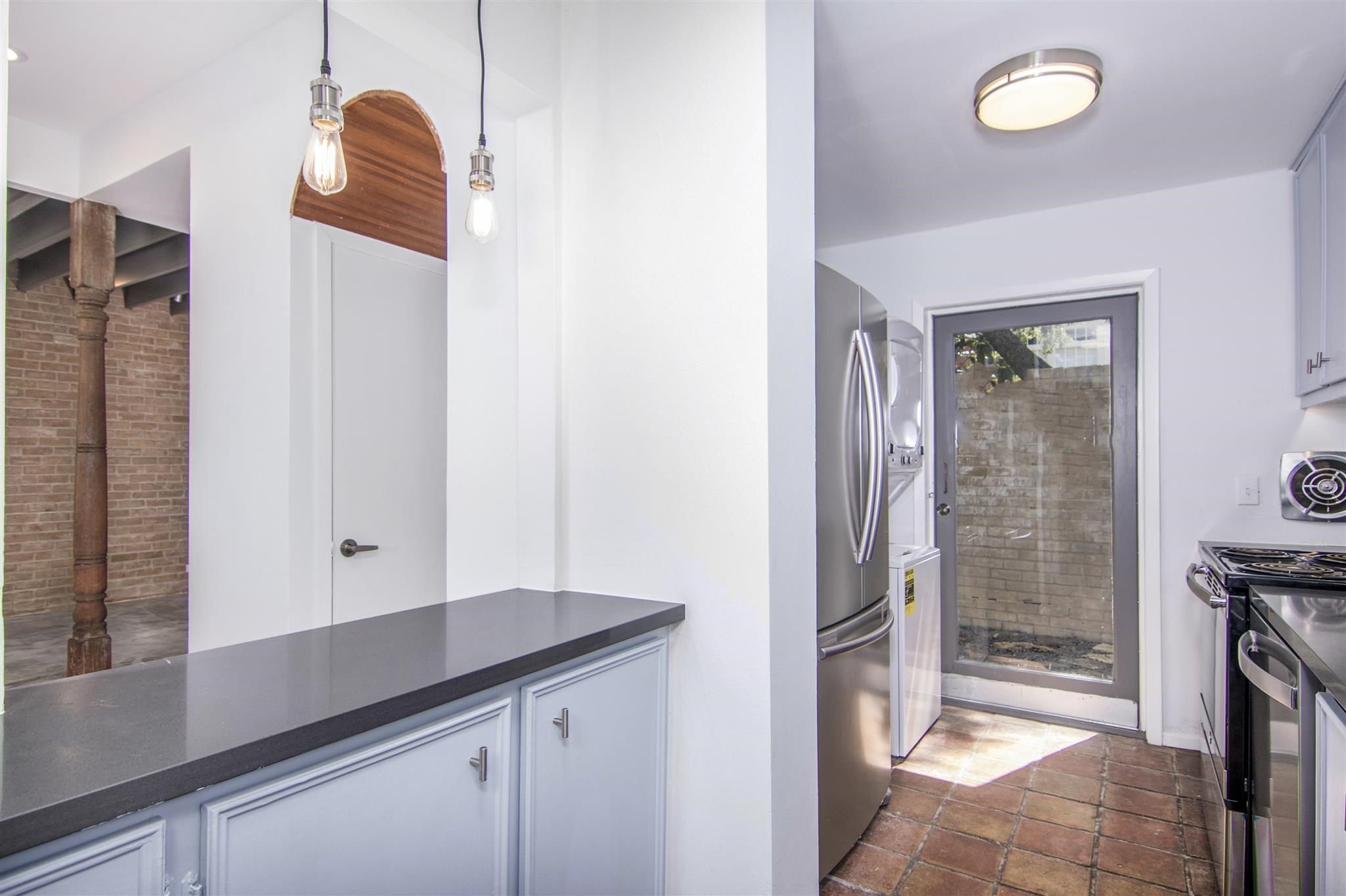 1942 Indiana Street Houston, TX 77019 - Photo 27 of 40 a kitchen with cabinets and a refrigerator