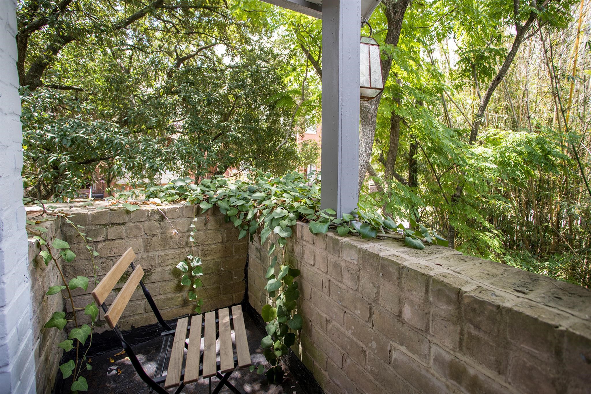 1942 Indiana Street Houston, TX 77019 - Photo 34 of 40 Another view of the cozy balcony, surrounded by greenery.
