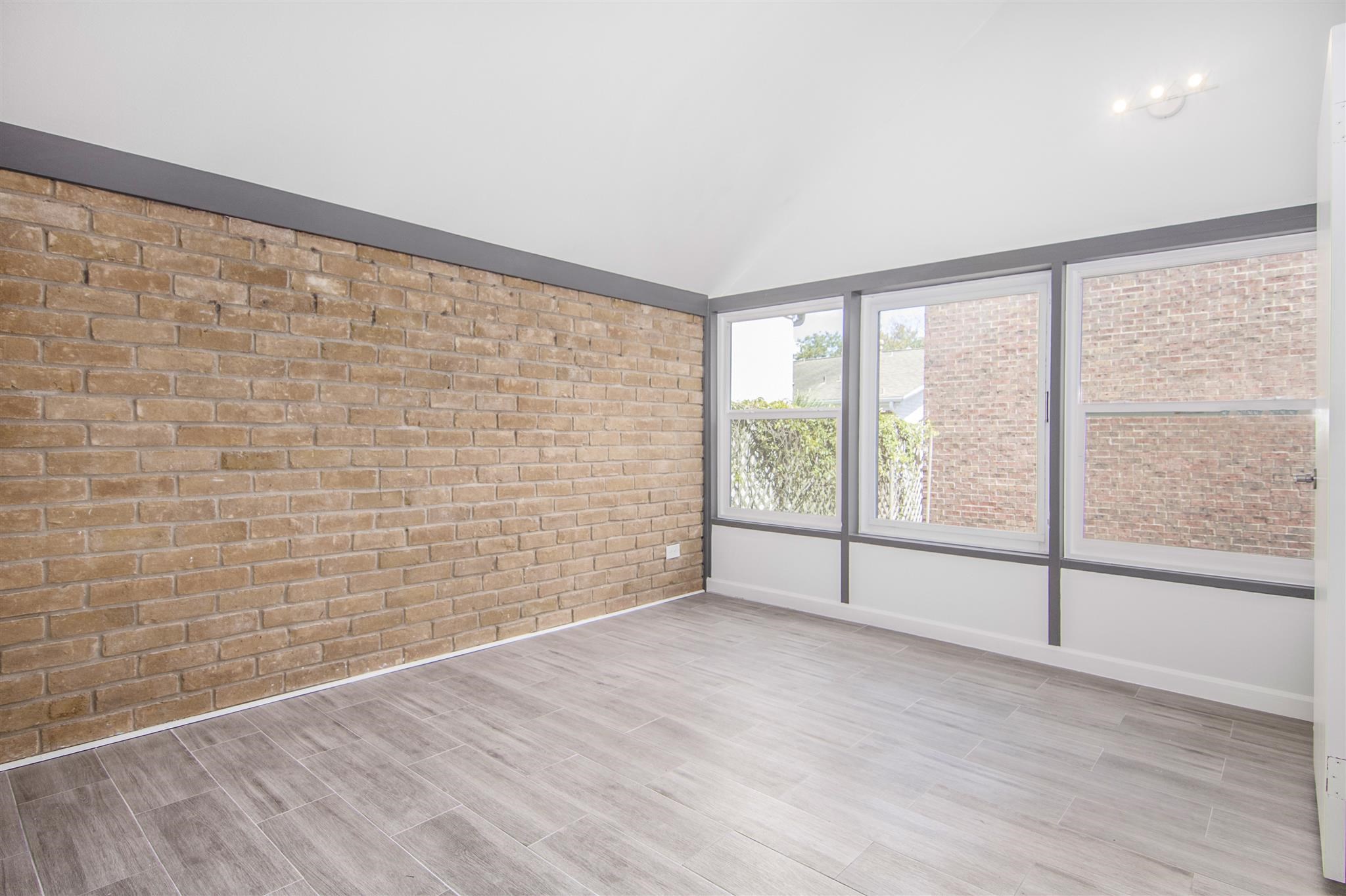 1942 Indiana Street Houston, TX 77019 - Photo 38 of 40 a view of an empty room with wooden floor and iron stairs
