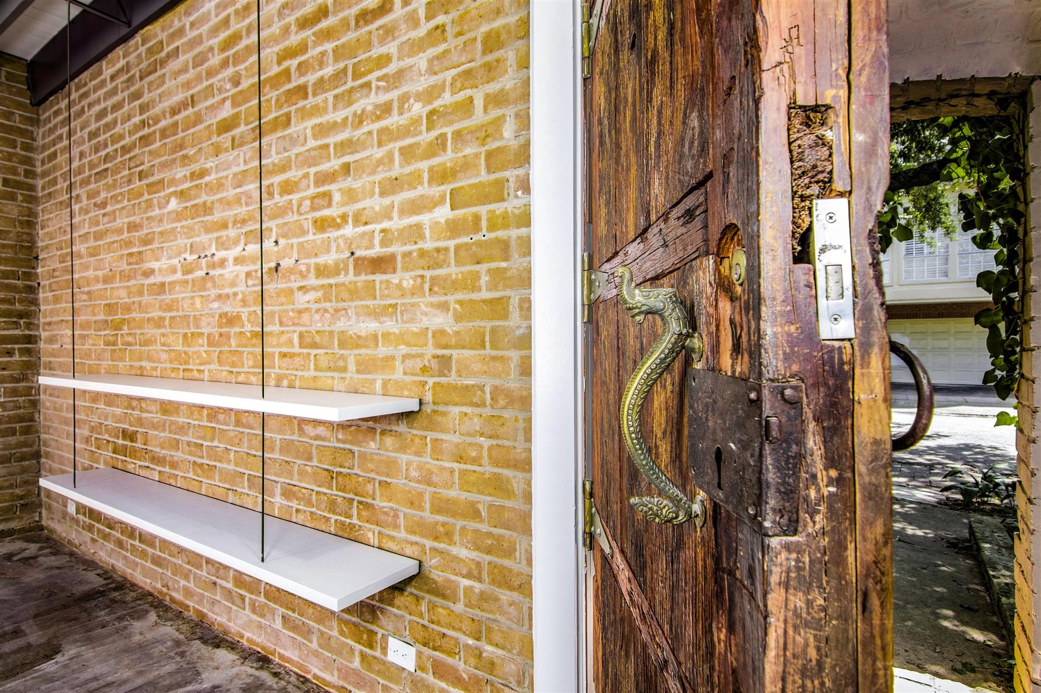 1942 Indiana Street Houston, TX 77019 - Photo 40 of 40 Truly unique custom home, designed and built by the late Houstonian architect and preservationist, Bart Truxillo. He brought back this draw-bridge-like wooden door from his overseas travels to complete his personal residence.