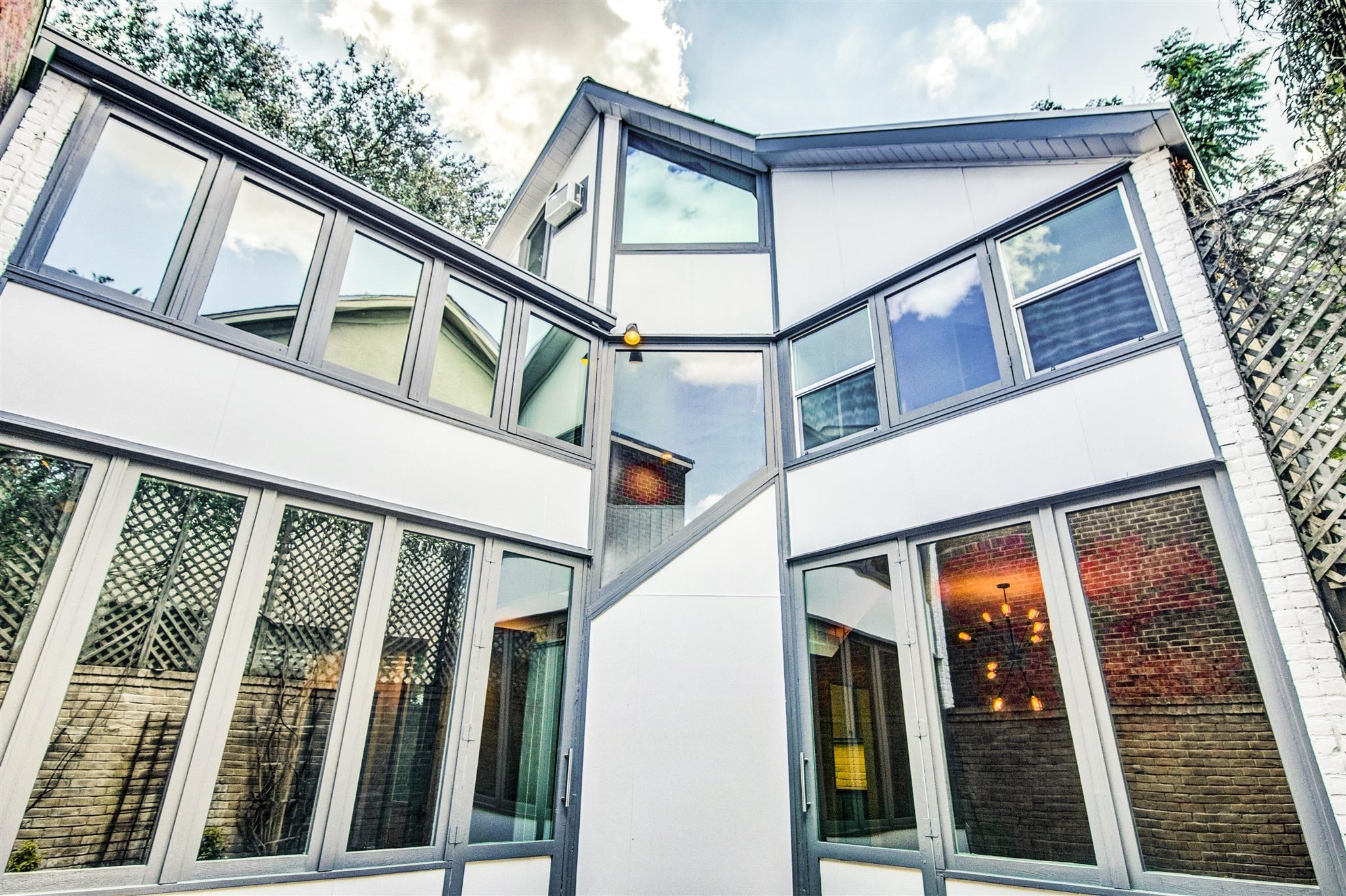 1942 Indiana Street Houston, TX 77019 - Photo 4 of 40 The entire back of the house is full of windows to provide ample natural light to all of the rooms in the house, while maintaining privacy, All but two of these windows have been replaced with new double-pane glass. All of the bedrooms and living spaces have the upgraded double-pane windows. The doors also have double-pane glass.