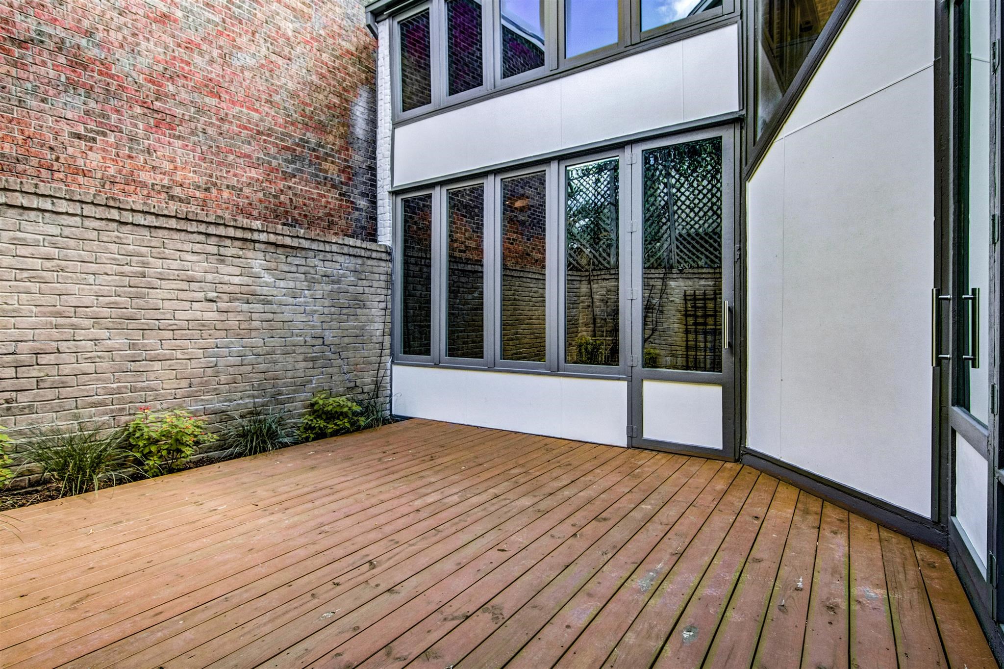 1942 Indiana Street Houston, TX 77019 - Photo 6 of 40 Back patio space has been updated - new photo forthcoming. Low maintenance back patio looking toward the living room. There's exterior storage in a shed to the left (not shown).