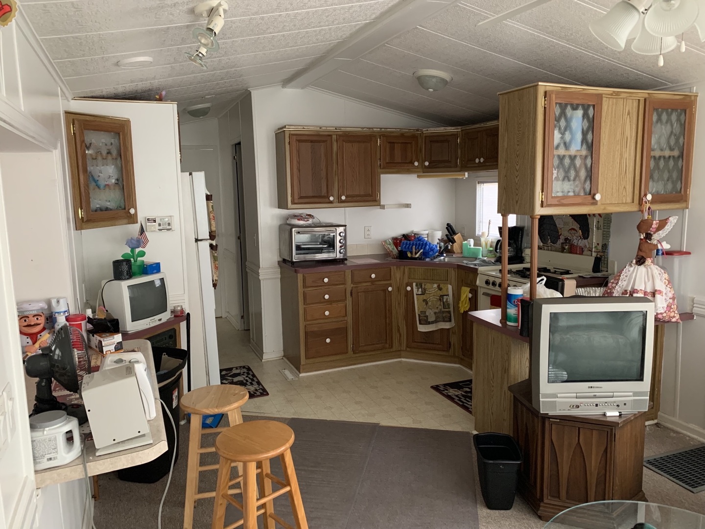 5-125 Woodhaven Sublette, IL 61367 - Photo 13 of 19 a kitchen with a refrigerator a stove top oven a sink dishwasher and wooden cabinets with wooden floor