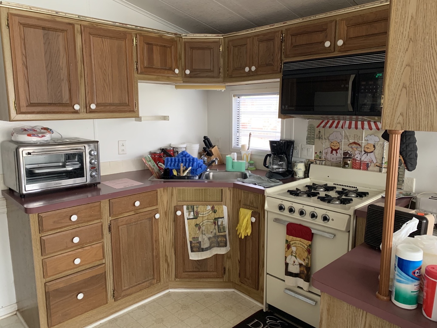 5-125 Woodhaven Sublette, IL 61367 - Photo 15 of 19 a kitchen with stainless steel appliances a stove a microwave and cabinets