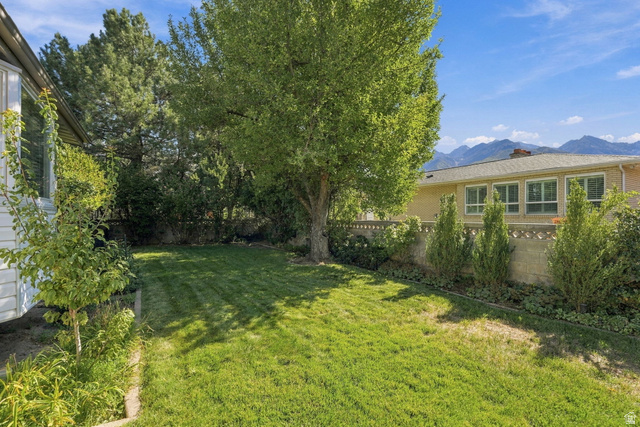 2524 Camelback Road Cottonwood Heights, UT 84121 - Photo 43 of 49 Expansive backyard featuring a manicured lawn, mature trees, and landscaping