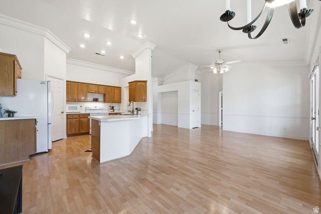 805 South River Road, Unit 70 St. George, UT 84790 - Photo 10 of 38 Open-concept living space featuring wood-finish flooring, vaulted ceilings with crown molding, and recessed lighting