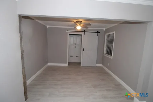 a view of an empty room with a fan