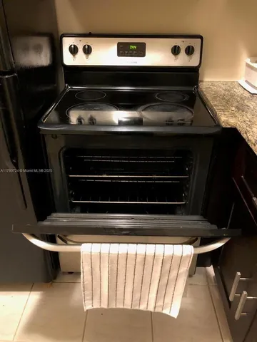 a stove top oven sitting inside of a kitchen