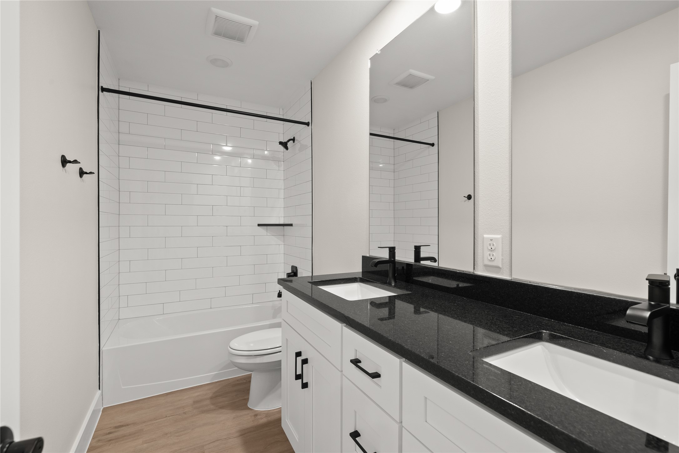 5514 Mobeetie Loop Bee Cave, TX 78738 - Photo 11 of 20 a bathroom with a granite countertop sink toilet a shower and a mirror
