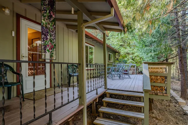 a backyard of a house with wooden floor and outdoor seating
