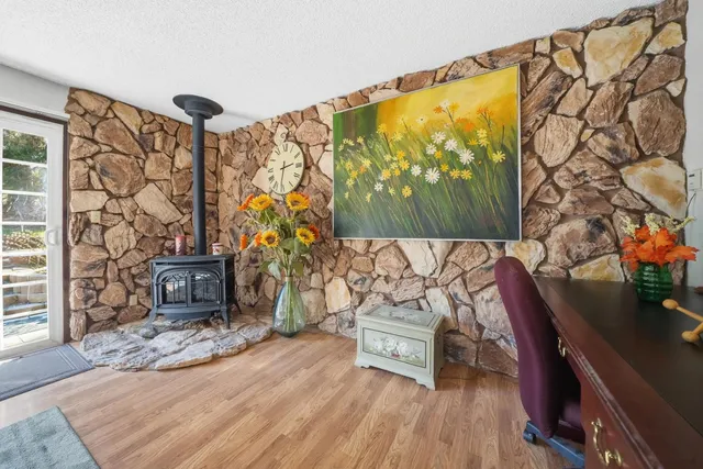 a living room with a couch and a table with wooden floor