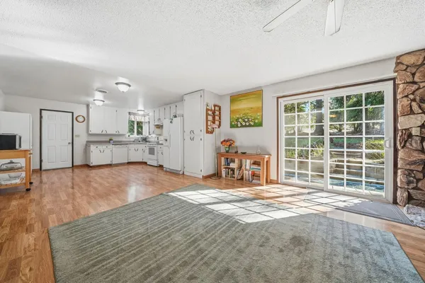 a view of a livingroom with furniture and a kitchen