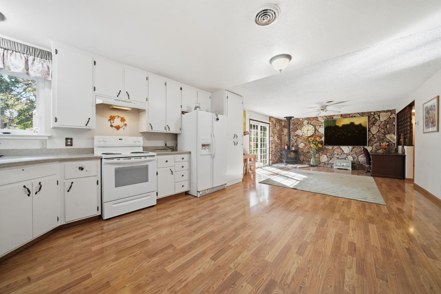 23420 Robin Road Pioneer, CA 95666 - Photo 20 of 43 a large white kitchen with cabinets a sink and appliances