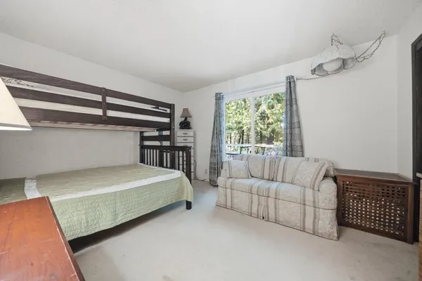 a bedroom with a bed couch and window