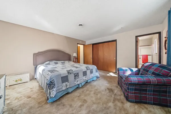 a bedroom with a bed and a couch