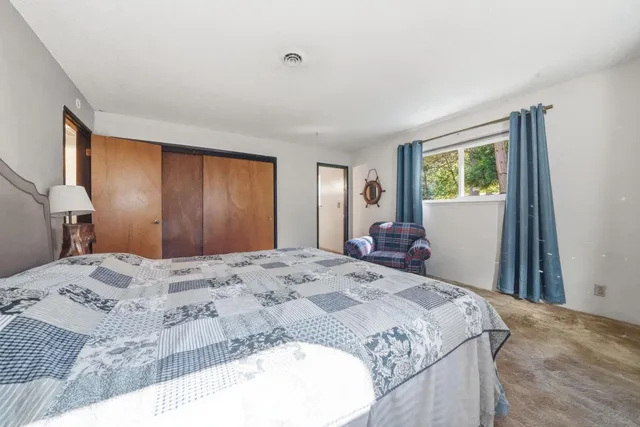 a bedroom with a bed and a dresser