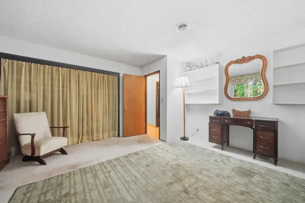 a bedroom with furniture and a window