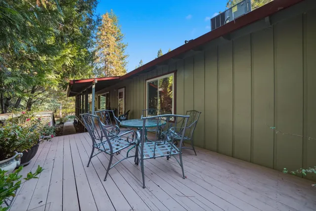 a patio with wooden floor and outdoor seating