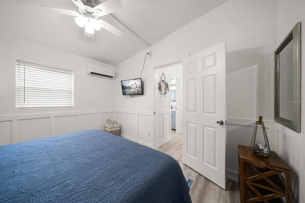 711 East Gulf Boulevard Indian Rocks Beach, FL 33785 - Photo 13 of 35 a bedroom with a bed and a chandelier