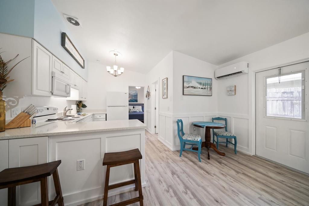 711 East Gulf Boulevard Indian Rocks Beach, FL 33785 - Photo 14 of 35 a kitchen with a sink cabinets and wooden floor