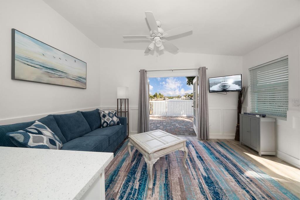 711 East Gulf Boulevard Indian Rocks Beach, FL 33785 - Photo 18 of 35 a living room with furniture and a wooden floor